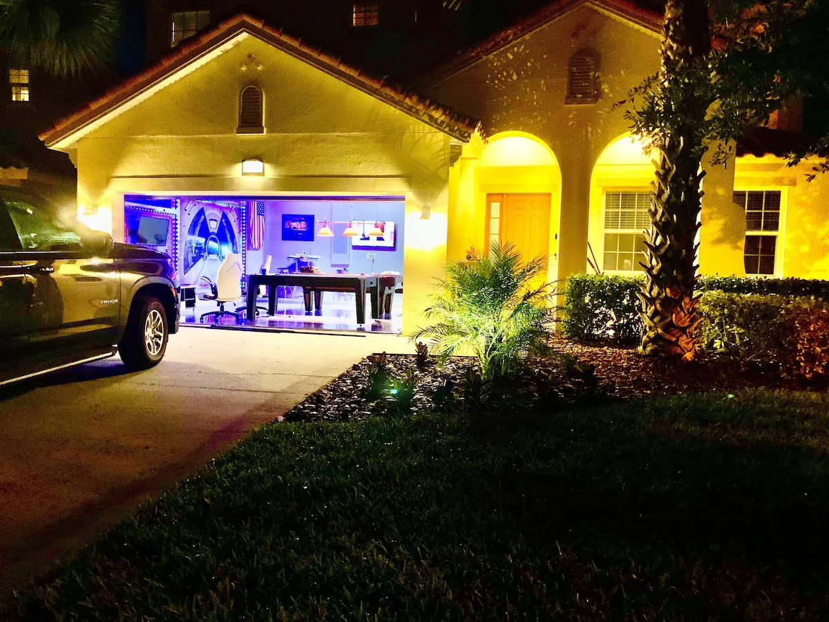 Disney Magical Escapes villa at night with the game room glowing