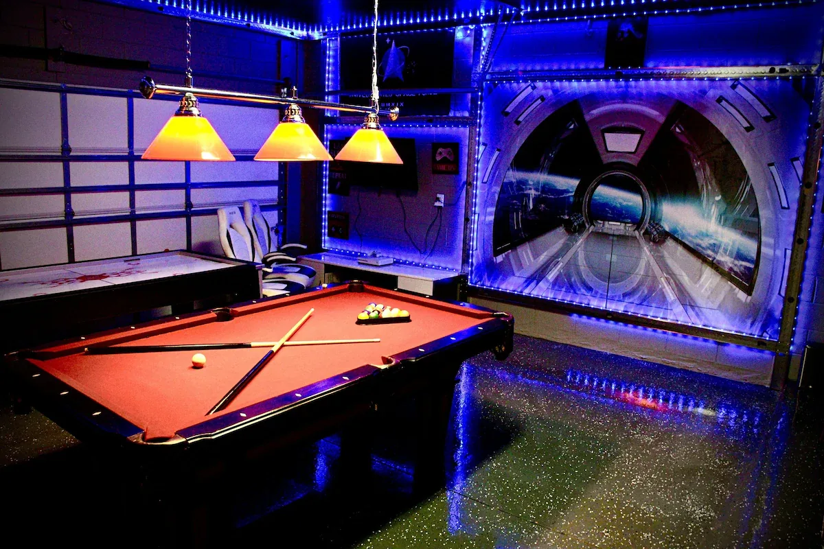Star Wars themed game room with pool table and neon lighting